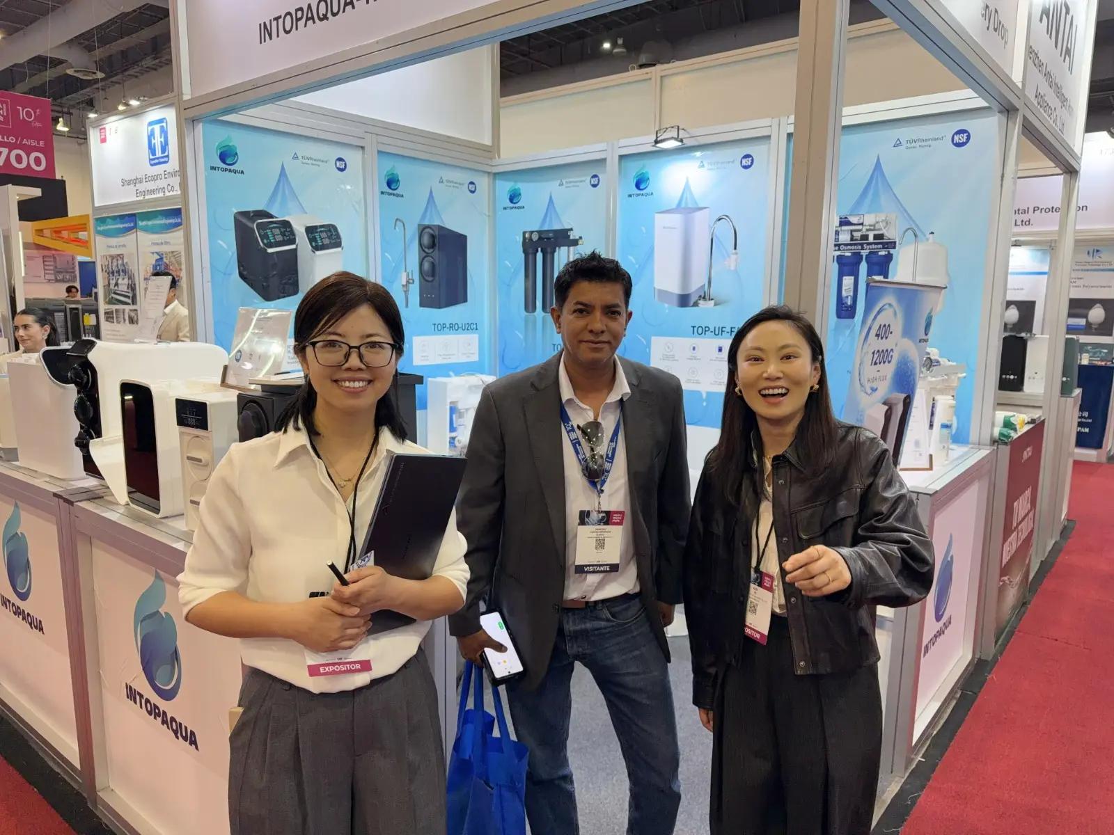 INTOP representatives with a visitor at Aquatech Mexico 2026